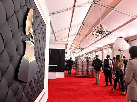 People walk on the red carpet as the celebrity arrival area is being set up ahead of the 62nd Annual Grammy awards at LA Live, in Los Angeles, California, on January 24, 2020.
