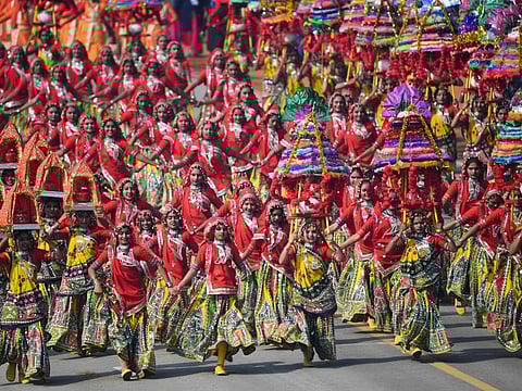Schoolchildren dance on Rajpath during the Republic Day parade in New Delhi on January 26, 2020.