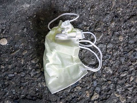 A discarded face mask lies on the ground outside Sunnybrook Hospital, where a patient is being treated in isolation for what Canadian health officials call the first presumptive confirmed case of novel coronavirus, in Toronto, Ontario, Canada.
