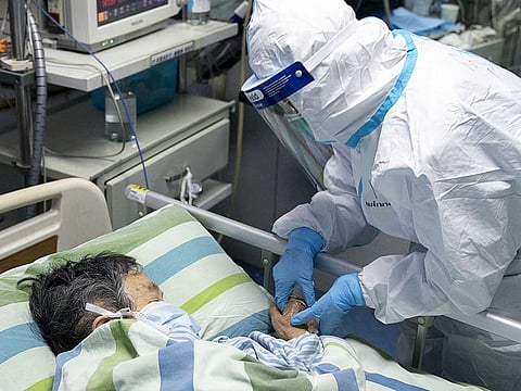 A medical worker attends to a patient in the intensive care unit at Zhongnan Hospital of Wuhan University in Wuhan in central China's Hubei Province.