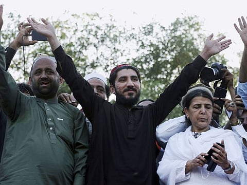 Manzoor Pashteen, center, a leader of Pashtun Protection Movement, waves to his supporters during a rally in Lahore on April 22, 2018. Pashteen was arrested in Peshawar on Monday.