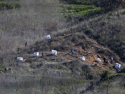 Investigators work at the scene of the helicopter crash, where former NBA star Kobe Bryant and his 13-year-old daughter Gianna died, on January 28, 2020 in Calabasas, California.