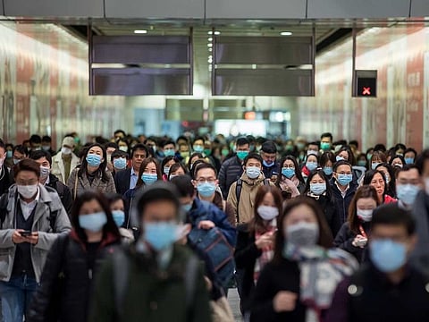 Commuters wearing protective masks walk through Hong Kong Station, operated by MTR Corp., in Hong Kong, China.
