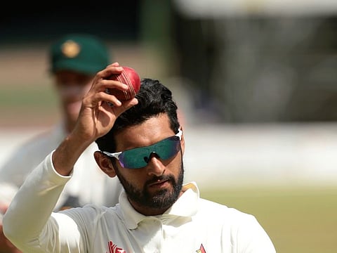 Sikandar Raza, the Zimbabwean spinner, shows off the ball which fetched him seven wickets on Wednesday.