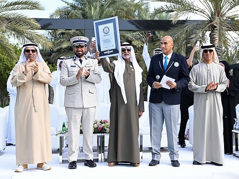Shaikh Nahyan holds the Guinness World Record certificate copy along with other officials.