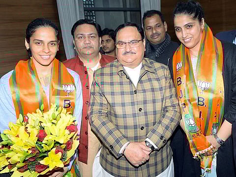 Ace badminton player Saina Nehwal and his sister Abu Chandranshu Nehwal along with BJP National President J.P. Nadda after join BJP, at BJP HQ in New Delhi on Wednesday. 