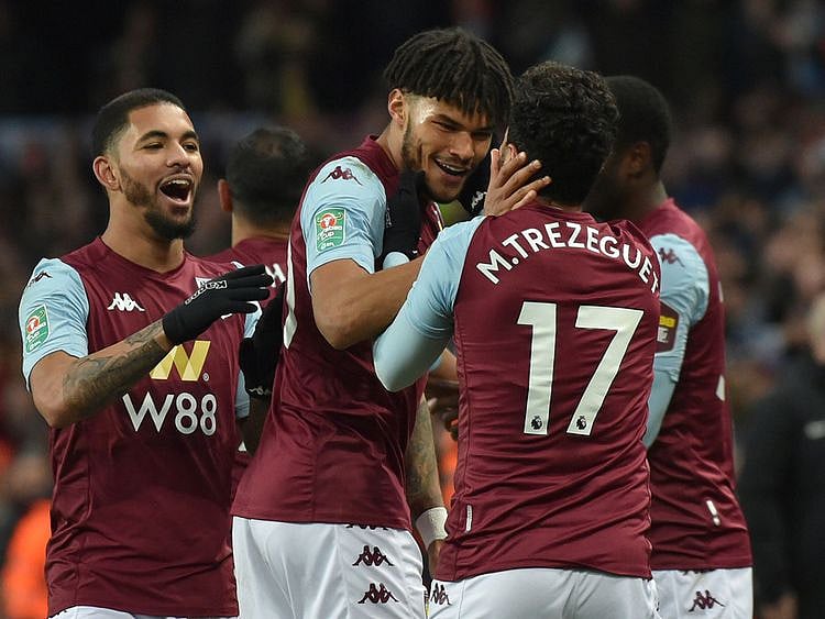 Trezeguet is mobbed by his Aston Villa teammates after his late winner against Leicester City in the League Cup semi-final.