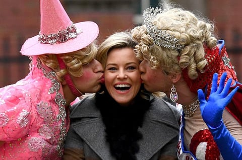 Actress and director Elizabeth Banks, Harvard University's Hasty Pudding Theatricals Woman of the Year, is kissed by theatrical students Eli Russell, President at Hasty Pudding Theatricals and Scott Kall during a parade through Harvard Square in Cambridge, Massachusetts, U.S., January 31, 2020.