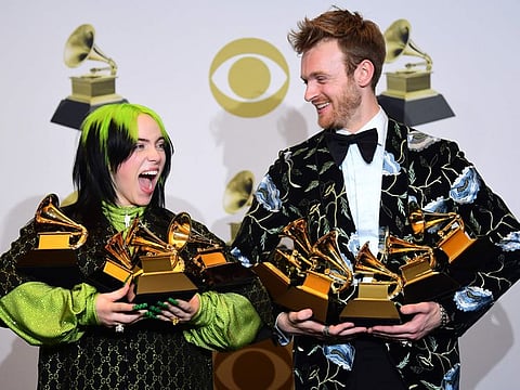 US singer-songwriter Billie Eilish (L) and Finneas O'Connell pose in the press room with the awards for Album Of The Year, Record Of The Year, Best New Artist, Song Of The Year and Best Pop Vocal Album during the 62nd Annual Grammy Awards on January 26, 2020, in Los Angeles.