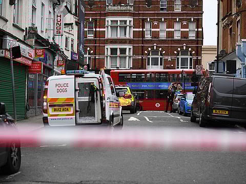 Police attend the scene after an incident in Streatham, London, Sunday Feb. 2, 2020. London police say officers shot a man during a “terrorism-related incident” that involved the stabbings of “a number of people.”