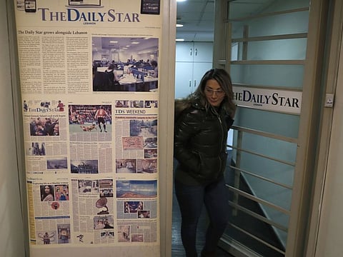 An employee of The Daily Star newspaper at the newspaper's office, in Beirut Tuesday. Lebanon's only English-language newspaper has announced that it's temporarily suspending its print edition because of financial challenges as the country passes through its worst economic crisis in decades. 