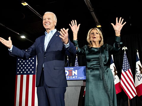 Former US Vice-President Joe Biden, 2020 Democratic presidential candidate, and his wife Jill Biden greet supporters during a caucus night watch party in Des Moines, Iowa on February 3.