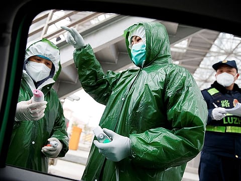 File picture: Medical workers and security personnel stand at a checkpoint as the country is hit by an outbreak of the novel coronavirus in Anqing, Anhui province, China