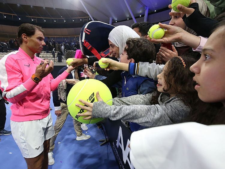 Rafael Nadal of Spain signs autographs for fans after an exhibition game to inaugurate the Rafa Nadal Academy Kuwait, at Shaikh Jaber Al Abdullah Al Jaber Al Sabah International Tennis Complex in the Kuwaiti capital, on February 5, 2020.  / AFP / Yasser Al-Zayyat