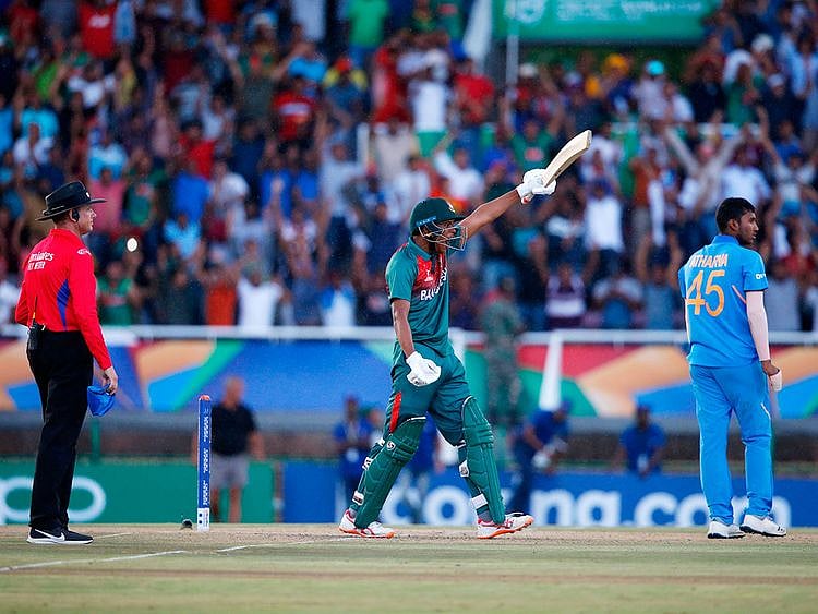 Bangladesh's Rakibul Hasan (C) celebrates after scoring the winning runs as India's Atharva Ankolekar and umpire Sam Nogajski (L) looks on at during the ICC Under-19 World Cup cricket finals at the Senwes Park, in Potchefstroom, on February 9, 2020. 