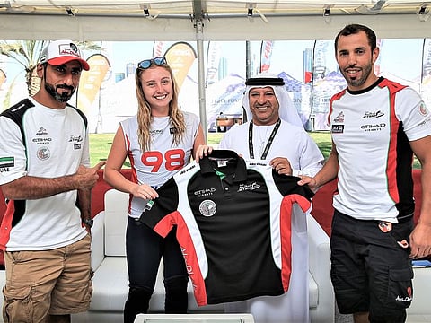Emma-Nellie Ortendahl with Salem Al Remeithi, General Manager of Abu Dhabi International Marine Sports Club, and new teammates Rashid Al Mulla (left) and Rashed Al Tayer