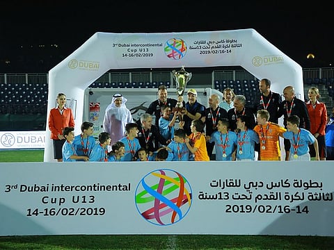 Last year's champions celebrate winning the trophy at the Dubai Sports City.