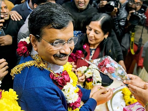 Delhi Chief Minister Arvind Kejriwal offers prayers at Hanuman Temple in Connaught Place as the party won Delhi Assembly Election, on Tuesday. 