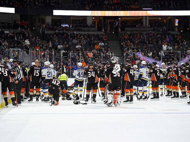 Members of the St. Louis Blues and Anaheim Ducks gather on the ice as Blues defenseman Jay Bouwmeester, who suffered a medical emergency, is worked on by medical personnel during the first period of an NHL hockey game Tuesday, Feb. 11, 2020, in Anaheim, Calif. (AP Photo/Mark J. Terrill)