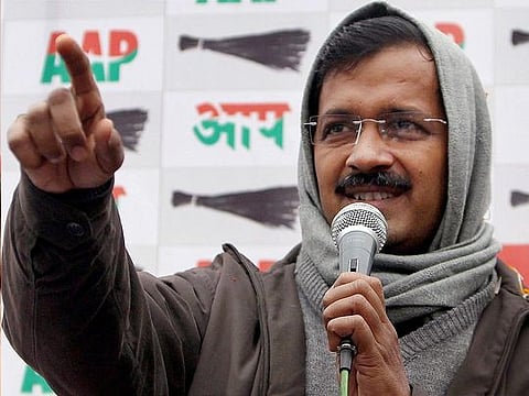Delhi Chief Minister Arvind Kejriwal greets the crowd as he arrives to meet Delhi Lieutenant Governor Anil Baijal, in New Delhi yesterday.