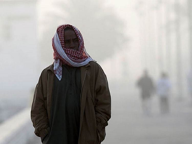 A chilly foggy morning on Jumeirah Open beach in Dubai.