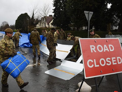 Members of the 4th Battalion Royal Regiment of Scotland erect flood barricades in Ilkley, West Yorkshire on February 15, 2020, as Storm Dennis sweeps in over the country. 