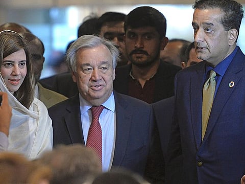 United Nations Secretary-General Antonio Guterres (C) arrives with Pakistan ministers Malik Amin Aslam (R) and Zartaj Gul during an event on sustainable development and climate change in Islamabad on February 16, 2020.