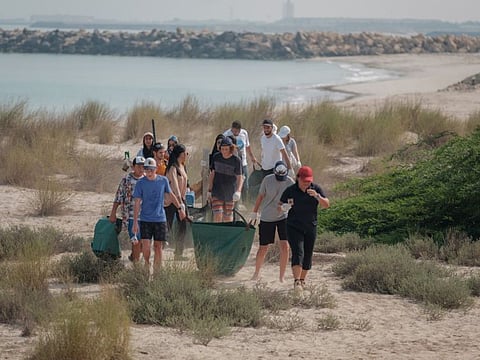 Emirates Nature – WWF volunteers during a beach clean-up drive at the Al Jurf Developments in Abu Dhabi.
