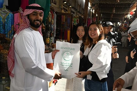 Dubai Police with some tourists at the Al Fahidi Historical Neighbourhood in Dubai