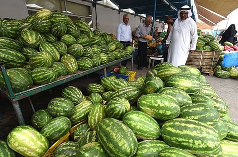 The customers select the watermelon at Mina Fruits and Vegetables Markets in Abu Dhabi