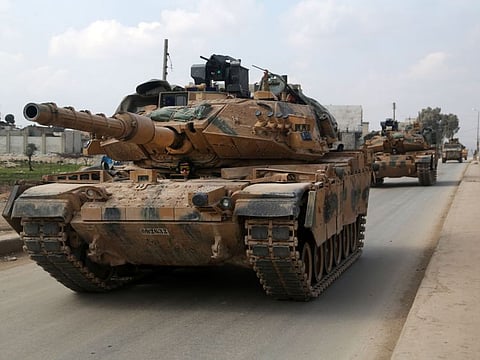 A convoy of Turkish M-60T tanks patrols in the town of Atareb in the rebel-held western countryside of Syria's Aleppo province on February 19, 2020.
 Turkey and Russia were engaged in a fresh war of words today after President Recep Tayyip Erdogan threatened an "imminent" operation in Syria to end the regime's brutal assault on the last rebel enclave. It came as Syrian aid workers issued an urgent call for a ceasefire and international help for nearly a million people fleeing the regime onslaught in the country's northwestern Idlib province -- the biggest wave of displaced civilians in the nine-year conflict. / AFP / Aref TAMMAWI