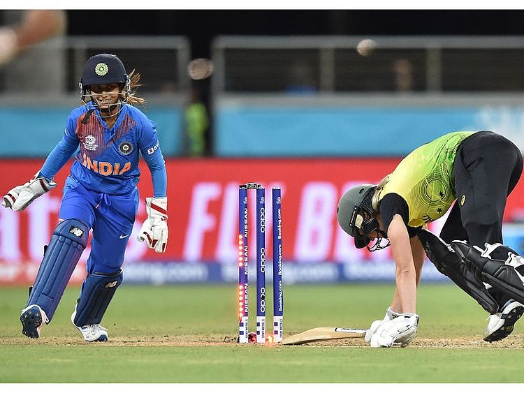 Australia's Ellyse Perry (R) is bowled on her first ball by India's Poonam Yadav during the opening match of the women's Twenty20 World Cup cricket tournament at the Sydney Showground in Sydney on February 21, 2020. --