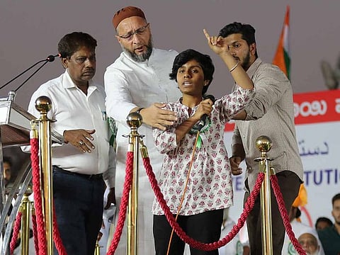 Indian lawmaker and President of the All India Majlis-e-Ittehadul Muslimeen (AIMIM) Asaduddin Owaisi, second left, prevents a student activist Amulya, second right, to continue talking after she raised pro-Pakistan slogans during a protest against a new citizenship law