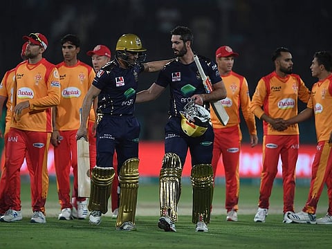 File photo: Quetta Gladiators' Ben Cutting (front R) and Abdul Nasir (front L) walk back the pavilion after winning the Pakistan Super League (PSL) Twenty20 cricket match between Quetta Gladiators and Islamabad United at The National Cricket Stadium in Karachi on February 20, 2020. 