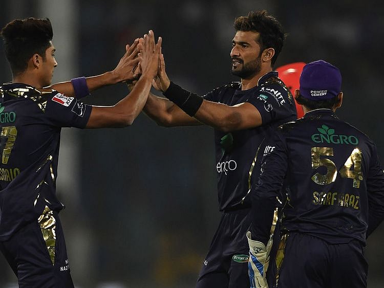 Quetta Gladiators's Sohail Khan (2R) celebrates with team mate Mohammad Hasnain (L) after the dismissal of Islamabad United's Amad Butt (unseen) during the Pakistan Super League (PSL) Twenty20 cricket match between Quetta Gladiators and Islamabad United at The National Cricket Stadium in Karachi on February 20, 2020.  / AFP / Asif HASSAN