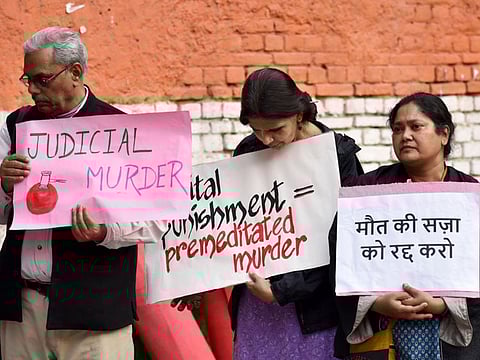Members of People’s Union for Democratic Rights stage a protest opposing the death penalty of the four convicts in the Nirbhaya case, in New Delhi on Wednesday. 