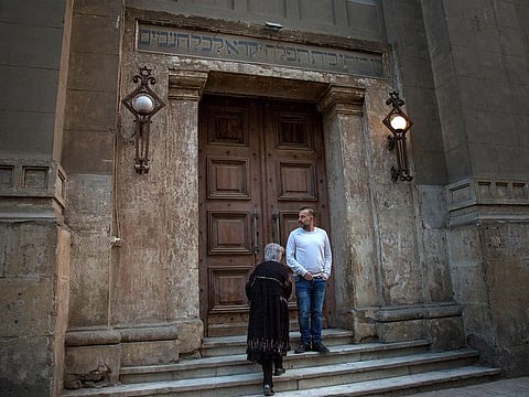 Doris Wolanski and her son, Simon, stand outside the entrance of  a synagogue, which she attended as a child, in Cairo