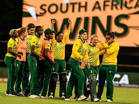 Mignon Du Preez of South Africa (2-R) leads her team in celebration after winning the Twenty20 women's World Cup cricket match against England in Perth on February 23, 2020.  