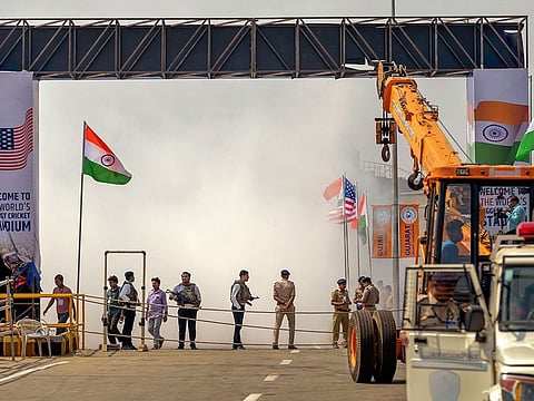 Workers use a crane to re-install a temporary gate at Motera Stadium, after it collapsed due to strong winds, in Ahmedabad, on Sunday.