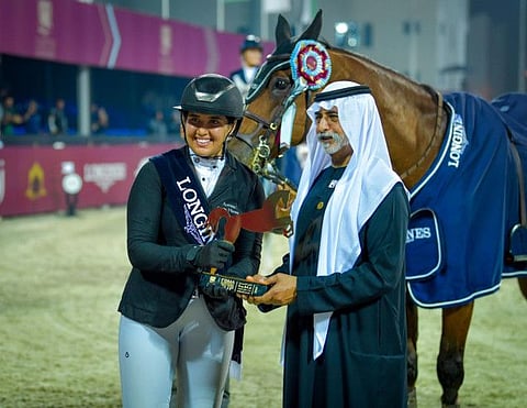 Shaikh Nahayan Mabarak Al Nahayan, the UAE’s Minister of Tolerance, presents the winner's trophy to Sara Hussein Saleh Al Armouti on the final day of the Fatima Bint Mubarak Ladies Sports Academy’s (FBMA) International Show Jumping Cup on Saturday.