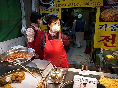 An employee from a disinfection service company sanitizes a restaurant at a traditional market in Seoul, South Korea, February 24, 2020.
