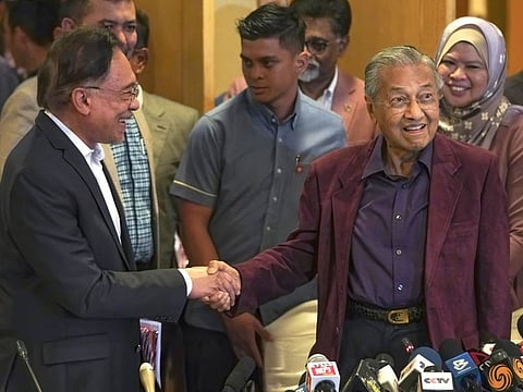 Malaysian Prime Minister Mahathir Mohamad shakes hands with Anwar Ibrahim in Putrajaya, Malaysia. 