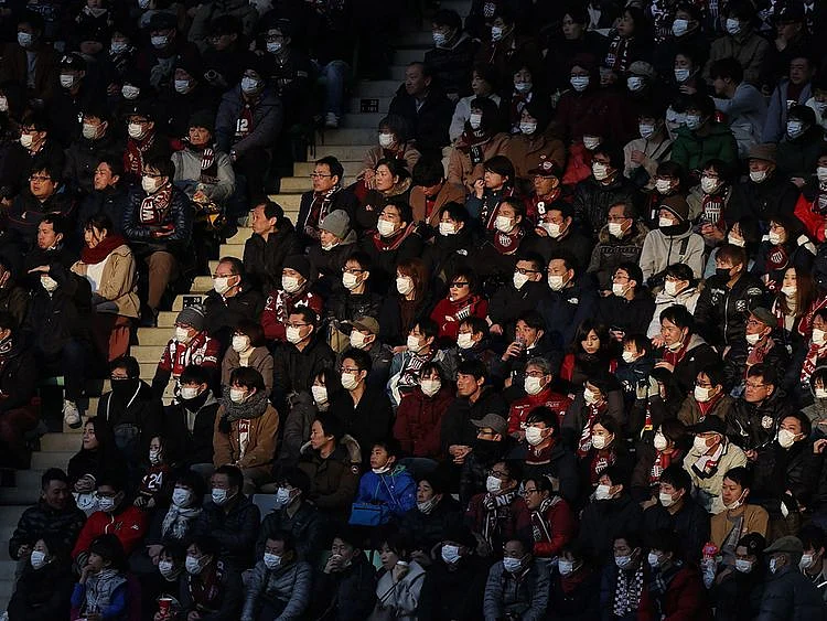 Fans wearing face masks at a J-League football match between Vissel Kobe and Yokohama F Marinos in February