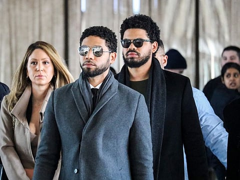 In this file photo taken on March 12, 2019 Actor Jussie Smollett(C) and team arrive for a court hearing at the Leighton Criminal Courthouse in Chicago.