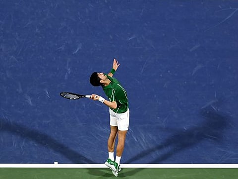 Serbia's Novak Djokovic serves the ball to Tunisia's Malek Jaziri during the Dubai Duty Free Tennis Championships