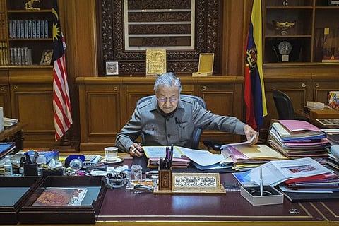 Malaysian Prime Minister Mahathir Mohamad works at his office in Putrajaya, Malaysia on Tuesday. 