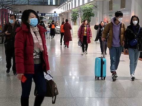 Passengers wearing masks are seen at the terminal hall of the Beijing Capital International Airport, in Beijing, China January 23, 2020. 