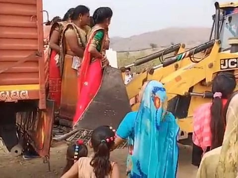 A video of women in India climbing into a loader has gone viral