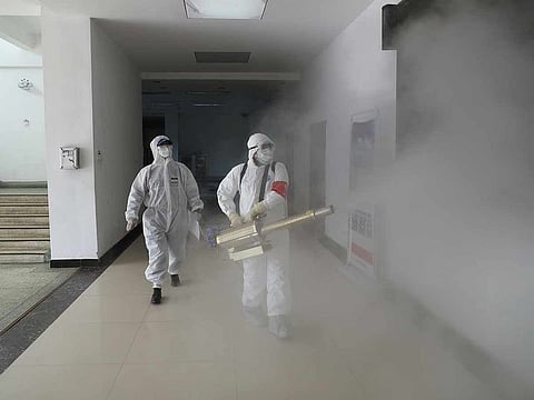 Volunteers in protective suits disinfect a residential compound in Wuhan, the epicentre of the novel coronavirus outbreak, in Hubei province, China February 22, 2020. 