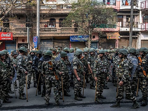 Security personnel stand guard in the streets of a Muslim-dominated area called Jafrabad in East Delhi on Feb. 26, 2020.